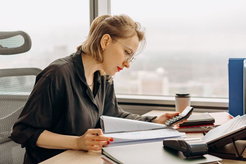 Accountant reviewing a client file at a desk